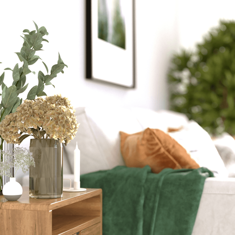 a vase with flowers on a table in a bedroom